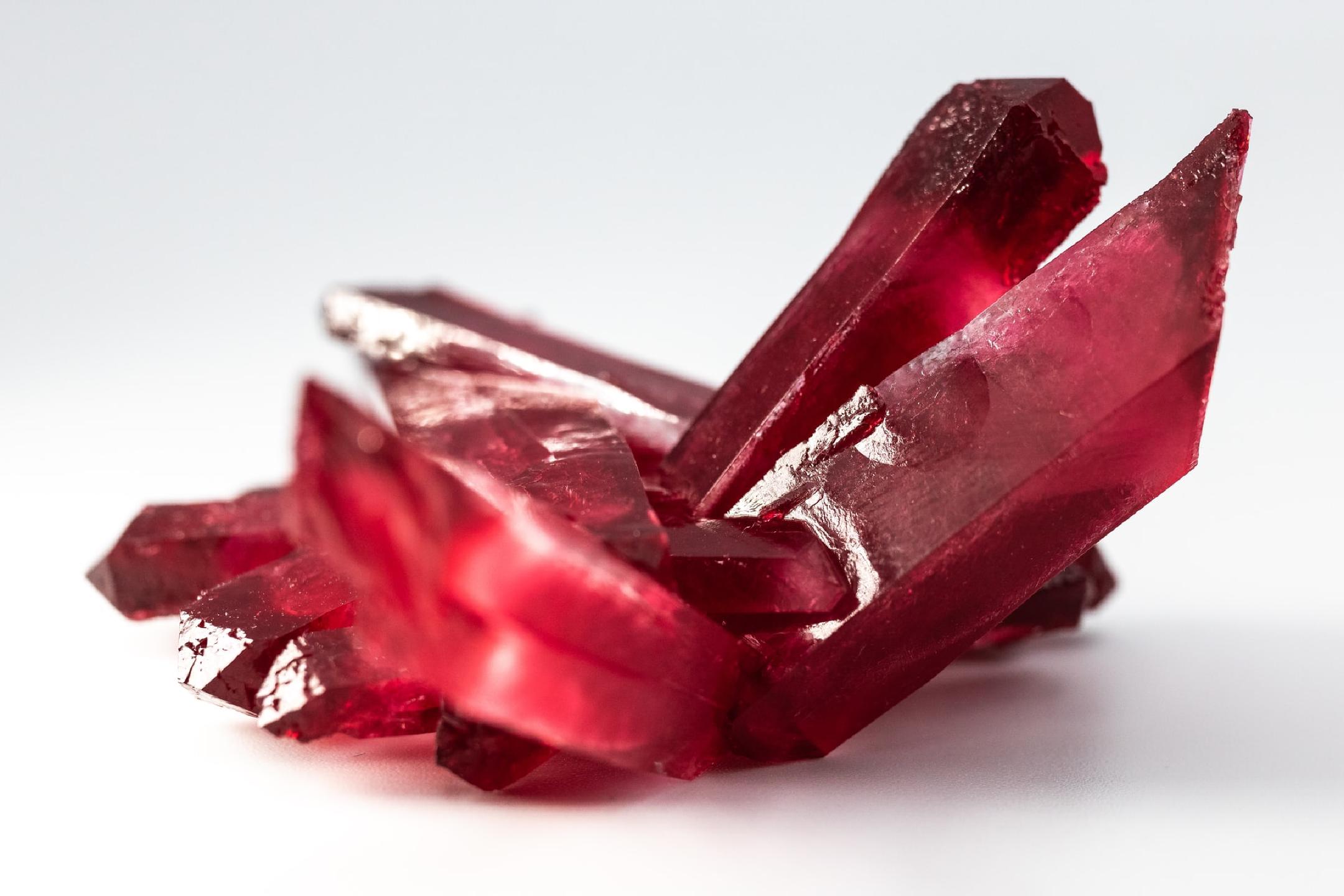 a dark red irregularly shaped piece of ruby mineral with many sharp corners