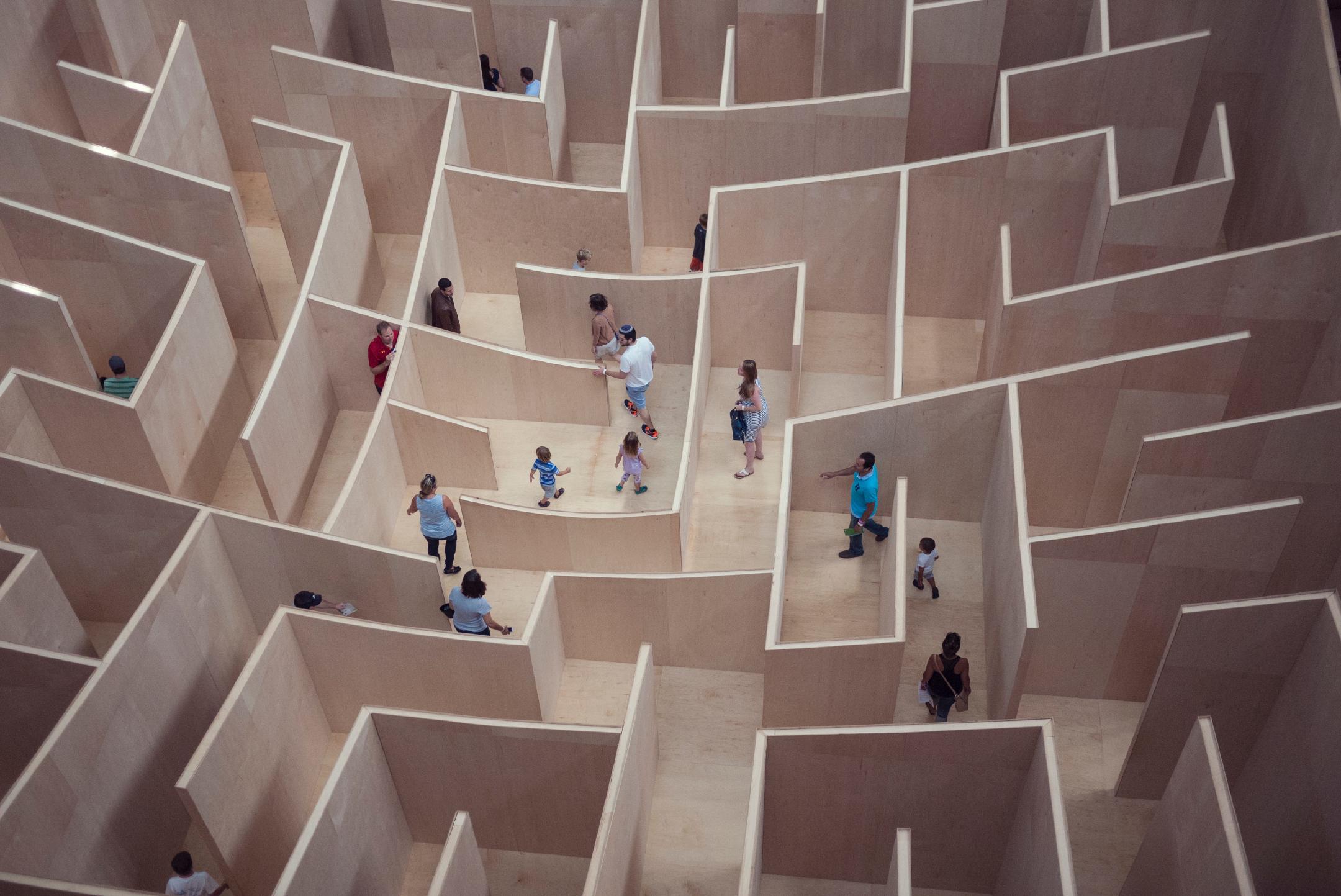 a top-down view of a large labyrinth with humans milling about